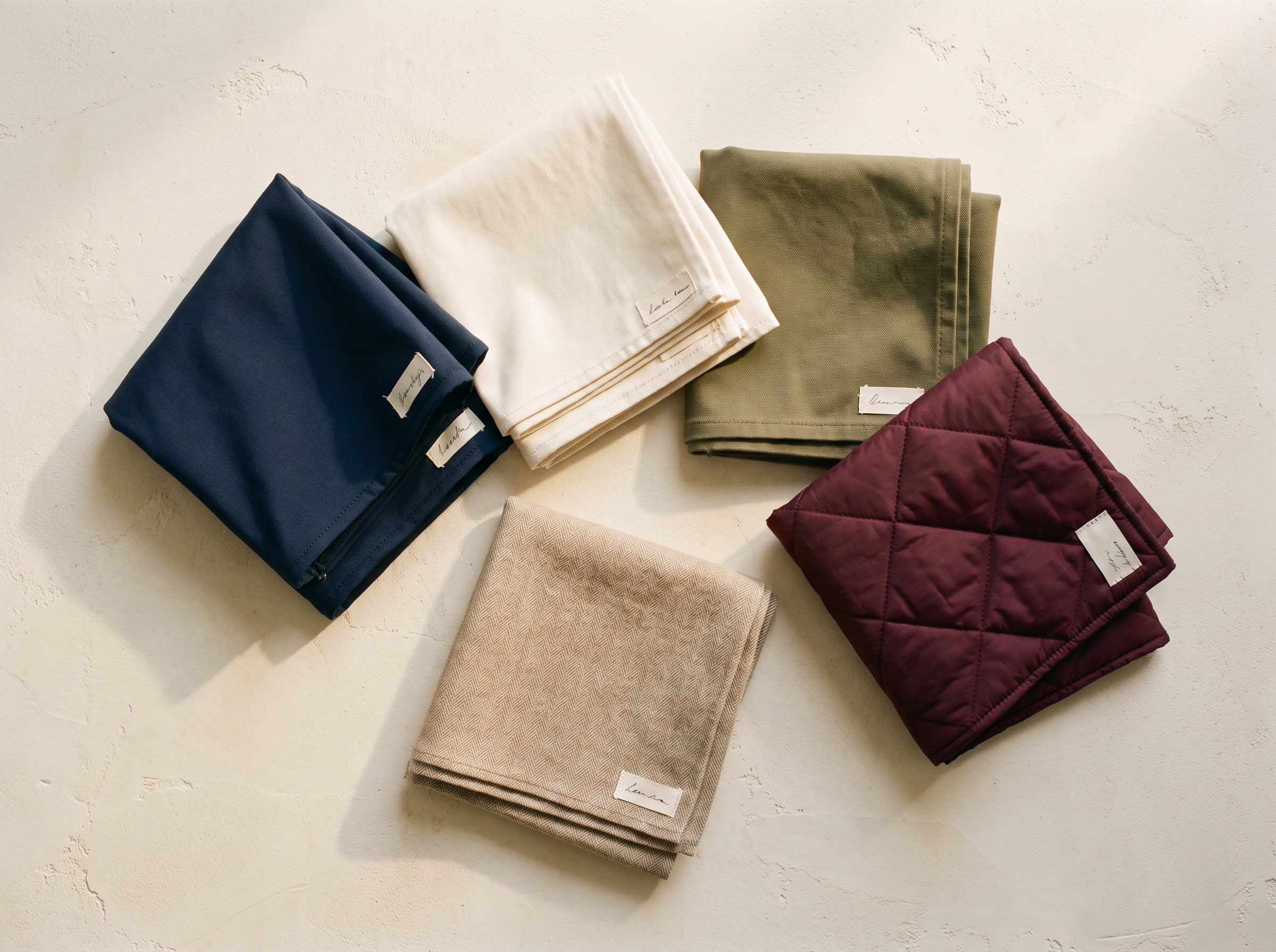 Fabric swatches with handwritten tags, studio
